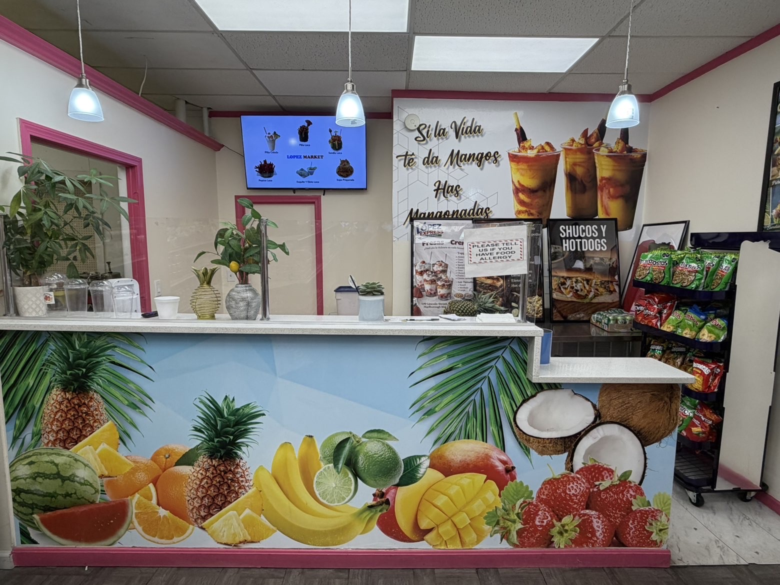 Lopez Market fruit counter with tropical mural